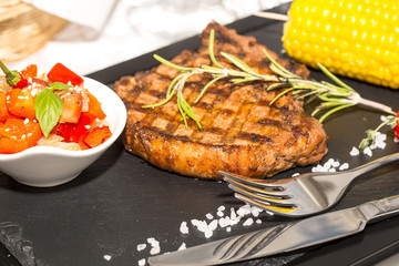 Grilled steak with sauce and greens 