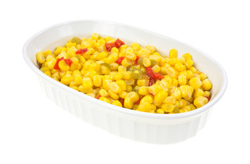 Serving bowl with cut corn and sliced peppers