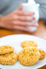 Cookies and woman holding a cup
