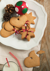 Christmas gingerbread cookies with festive decoration on the pla