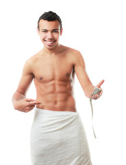 Fototapeta premium A nude young man covering himself with a towel
