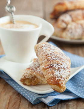Breakfast with cup of coffee and croissants