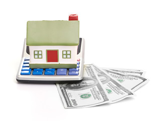 house sitting with a calculator and dollar