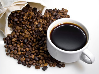 white cup of coffee with coffee beans