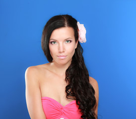 beautiful woman with flower over blue background