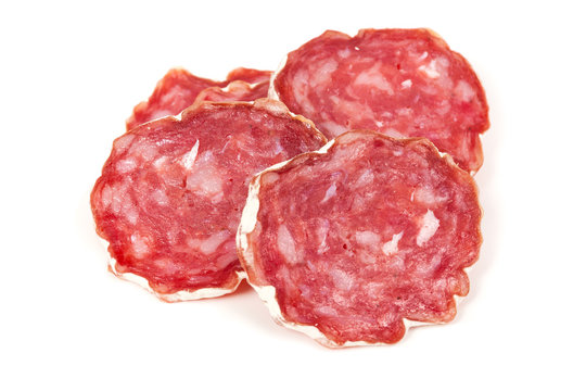 pile of salchichon, red spanish salami, on a white