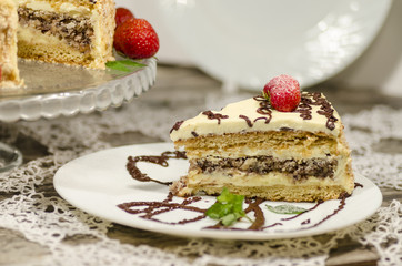 Slice of homemade cake with strawberries and mint