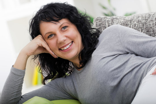  woman relaxed lying on couch at home