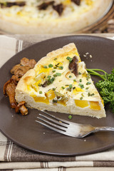 Piece of quiche lorraine on brown plate. Autumn setting