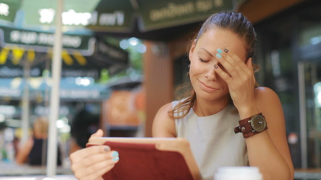woman sitting in a cafe, she looks very sad