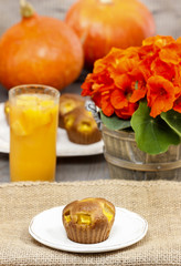 Muffins on wooden table in autumn setting