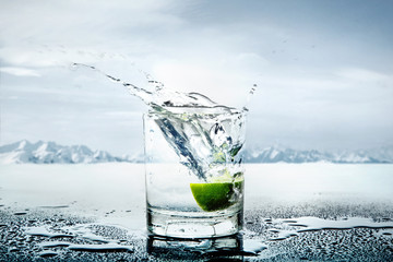 Art picture of lemon thrown to the glass of water