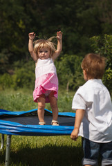 baby girl jumping on trampoline