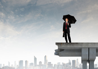 Businessman standing on bridge