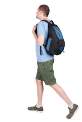 Fototapeta premium back view of walking man with backpack.