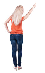 Obraz premium Back view of pointing woman. beautiful blonde gir