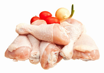 Raw chicken legs with vegetables, isolated on white background