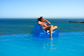 Fashionable Girl Relaxing in the Pool. Summer Vacation