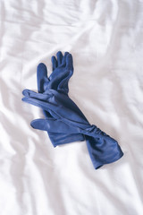 blue gloves on a white sheet