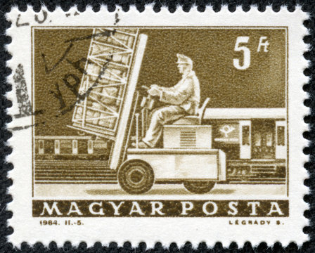 stamp printed in Hungary shows Post loading
