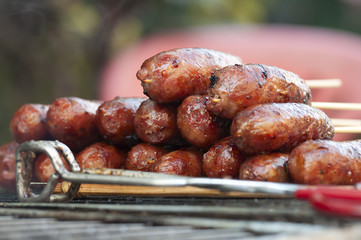 Grill with spicy street food. Sausage close up. Selective focus.