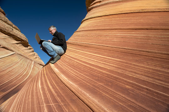 Business man in a canyon - Powered by Adobe