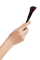 Female hand holding a makeup brush