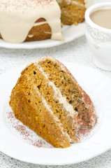 piece of carrots and pumpkin cake with coffee cream on a plate