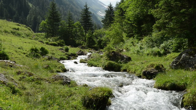 Zoom out of Stream water and landscape Zillertal Alps