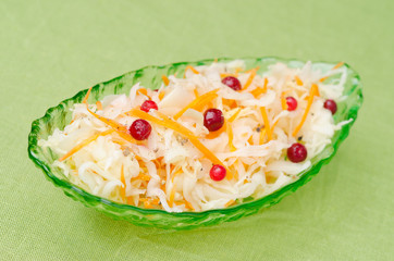 salad of pickled cabbage with carrots and cowberry in a bowl