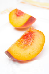 slice of fresh peach on a plate, close-up