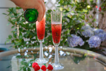 Summer cocktail with champagne and fresh raspberries