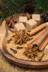 Obraz na płótnie Canvas spices and brown sugar for a Christmas baking in a wooden bowl