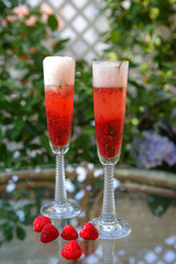 Summer cocktail with champagne and fresh raspberries