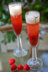 Summer cocktail with champagne and fresh raspberries