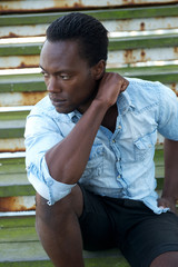 Handsome black male model sitting outdoors