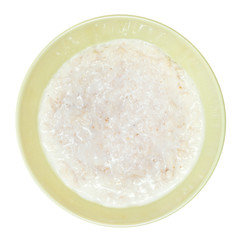 Fototapeta na wymiar oat porridge with milk in green bowl
