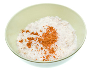 oat porridge with cinnamon in ceramic bowl