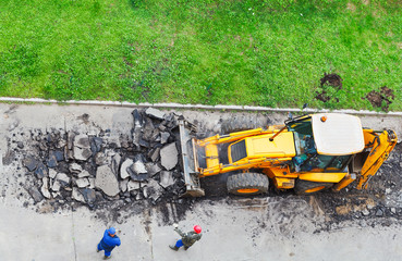 tractor removes asphalt