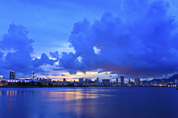 City skyline silhouetted against a blue sunset