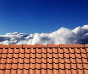 Roof tiles and sunny sky with clouds