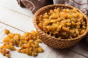 Raisins on wooden background