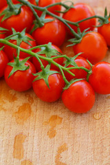 Cherry tomatoes, vegetables on background