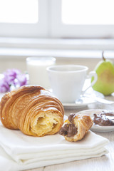 Croissants with chocolate, milk and coffee, delicious breakfast