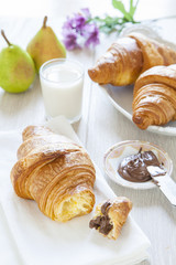 Croissants with chocolate, milk and coffee, delicious breakfast