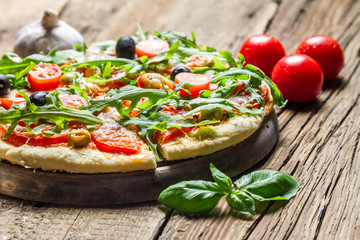 Freshly baked pizza with basil and tomatoes