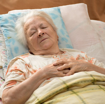 Senior woman lying at bed