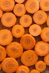 Chopped carrot circles against wood