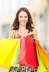 woman holding color shopping bags in mall