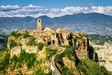 Ancient city on hill in Tuscany on a mountains background.